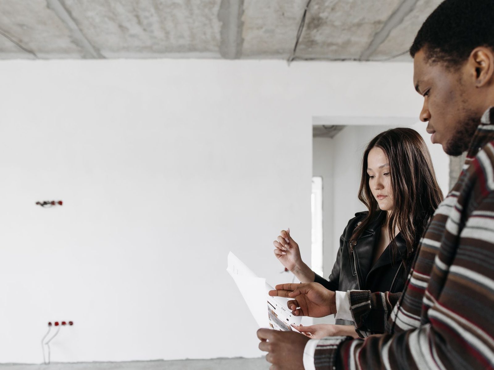 Interior designer reviewing renovation plans with a homeowner.